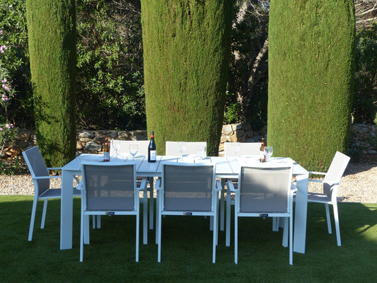 Miami Extending Dining Set with eight stackable chairs on an outdoor terrace